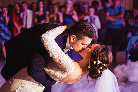 First wedding dance, groom and bride kissing while dancing