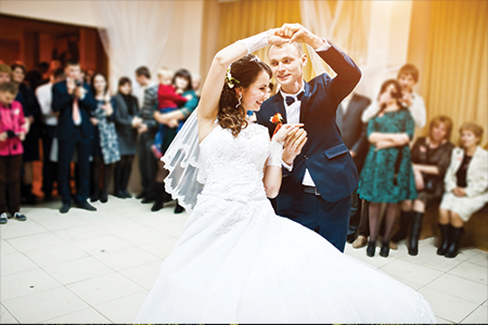 First wedding dance, groom spinning bride while dancing