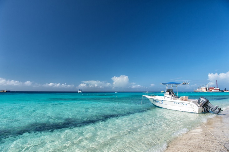 Boat floating by the white sand shores of Turks and Caicos