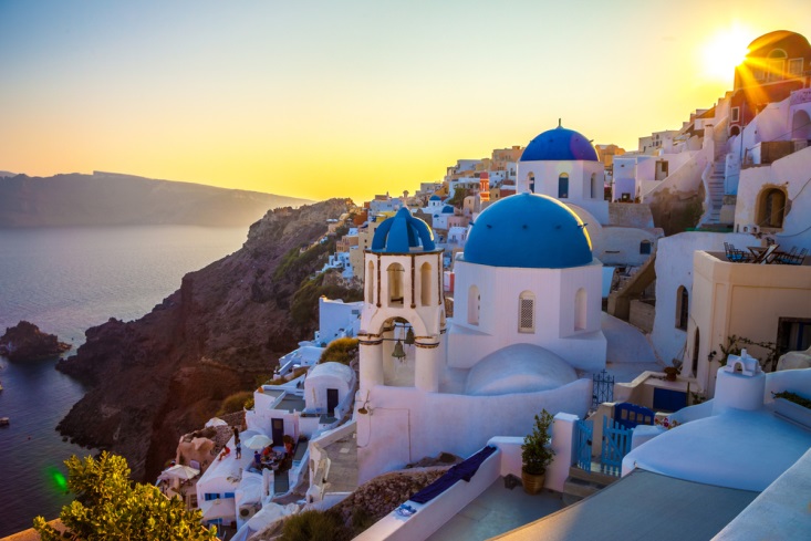 Blue rooves and white buildings of Santorini, Greece at sunset