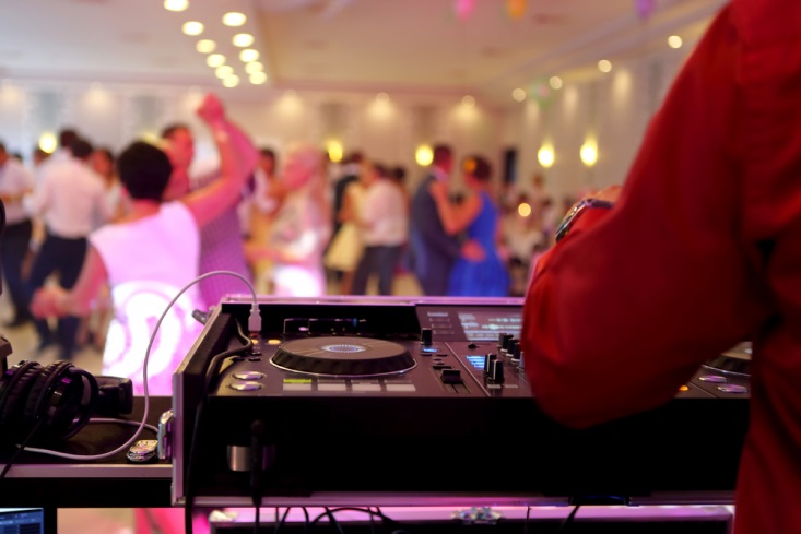 DJ playing music for guests at reception