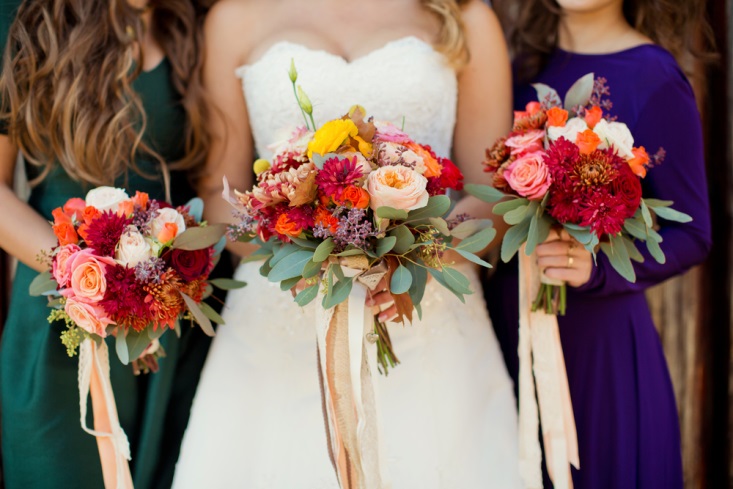 Bride and bridesmaids with fall-inpsired bouquet