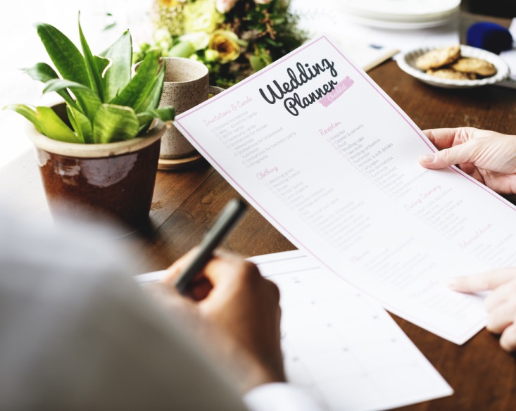 Wedding planner and bride going through checklist