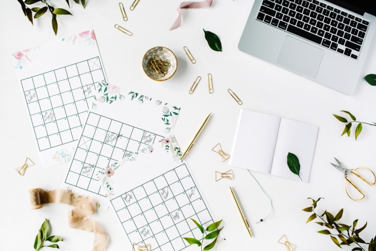 Green and white wedding calendars splayed out during wedding planning